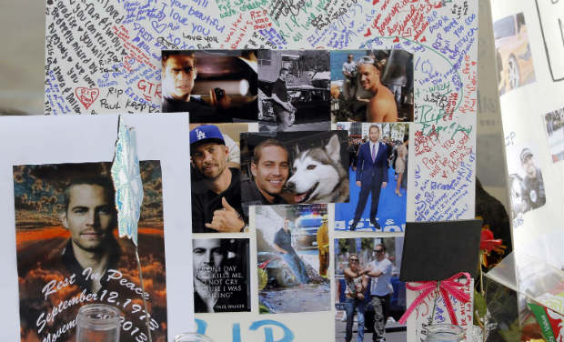 Photos and messages are seen at a roadside memorial at the site of the auto crash that took the life of actor Paul Walker and his friend Roger Rodas, in the small community of Valencia, California. -AP Photos and messages are seen at a roadside memorial at the site of the auto crash that took the life of actor Paul Walker and his friend Roger Rodas, in the small community of Valencia, California. -AP